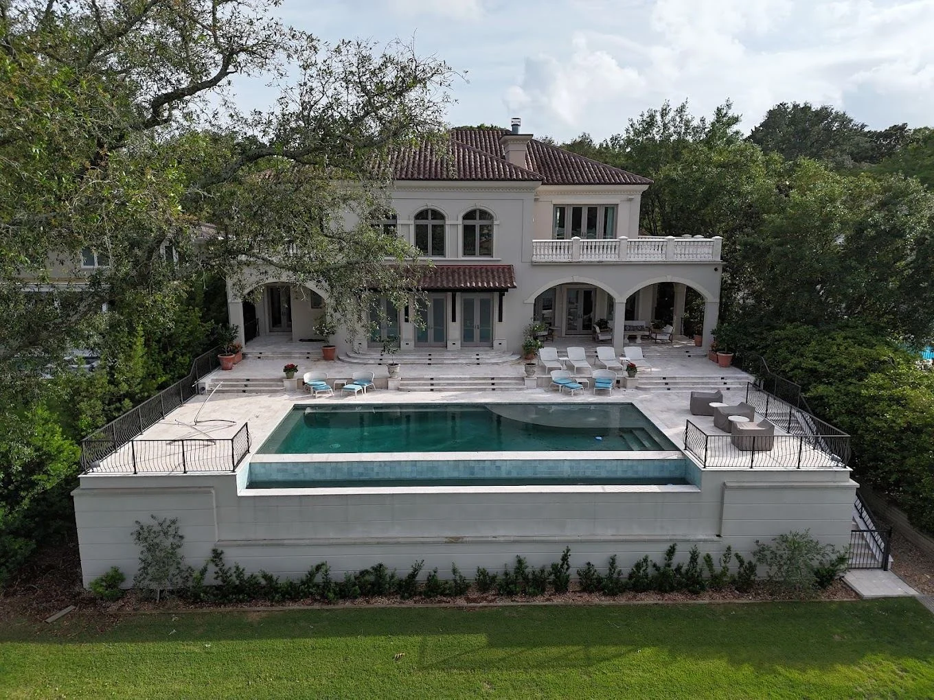 Mediterranean estate with an infinity pool and travertine terrace